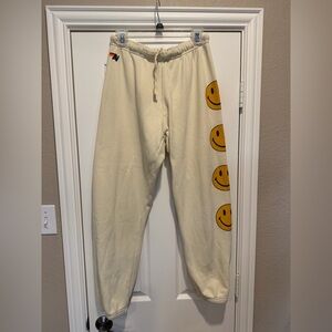 Aviator Nation White Joggers with Yellow Smiley Faces